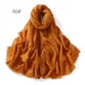Detail view of solid color cotton linen crinkle scarf fringe shawl texture close up - Pink