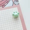 Close-up detail of shiny green AB acrylic cat paw bead, perfect for DIY jewelry crafting items. - Green
