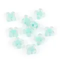 Close-up detail of translucent acrylic four-leaf clover beads for DIY jewelry making use. - Green