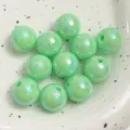 Detailed close-up shot of glossy green acrylic rainbow beads showcasing iridescent AB surface sheen. - Green