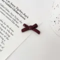 Close-up detail of burgundy bow bead, perfect for DIY bracelet making and jewelry accessories. - Wine Red