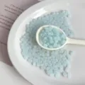 Detailed close-up of light blue acrylic peanut beads for DIY handmade jewelry accessories. - Lake Blue