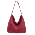 Detailed view of the vintage burgundy suede shoulder bag, showing soft texture and roomy shape. - Burgundy