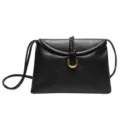 Minimalist black leather shoulder bag with chic metal ring closure and soft envelope design for women. - Black