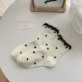 Cute white mid-tube socks with black heart pattern and delicate lace trim for daily wear - Cream Heart Lace