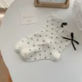 Women white polka dot cotton mid-calf socks with black bow sweet aesthetic main product view - Cream Polka Dot Ribbon
