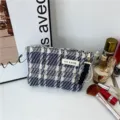 Tweed cosmetic bag with elegant plaid pattern and pearl handle for daily makeup storage. - Dark Blue