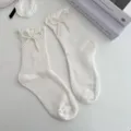 White mid-tube socks featuring pearl bows and ruffle trim, cute Japanese Lolita style socks. - One Size / Bowknot White