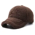 Close-up detail of the brown sherpa fleece baseball cap texture and fuzzy fabric for autumn. - Adjustable / Coffee