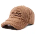 Brown fuzzy shearling baseball hat detail shot, soft plush fabric texture, warm winter cap. - Deep Beige