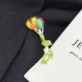 Close-up detail of cute colorful balloon frog brooch, exquisite enamel alloy accessory. - Frog with Balloons / Green Multi-color