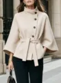 Beige wool blend short coat with stand collar, asymmetric buttons, and self-tie belt. - S / Tops / Apricot