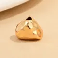 Close-up detail of irregular gold hammered triangle spacer bead for jewelry DIY crafting. - Gold Hammered Triangle Bead