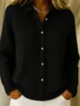 Close-up of a black waffle knit long sleeve button-up cardigan sweater for women. - S / Black