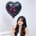 18 inch black heart foil balloon for birthday party decor held by smiling model - Bilingual Happy Birthday / Pack of 5 / Rose Red