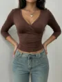 Detailed view of the women's slim-fit crossover V-neck 3/4 sleeve top in brown. - Dark Brown