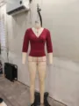 Close-up detail of burgundy cross V-neck slim 3/4 sleeve top displayed on mannequin stand. - S / Tops / Burgundy