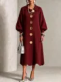 Detailed view of the burgundy knit dress featuring oversized metallic buttons and lantern sleeves. - S / Dresses / Burgundy