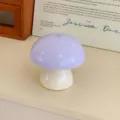 Close-up detail shot of the cute purple mushroom night light with touch switch for desk decor. - Beige