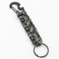Paracord keychain detail showing the woven tactical cord and black metal carabiner opener. - Forest Camo