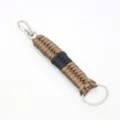 Close-up of handmade paracord keychain detail with durable woven brown and black nylon rope. - Brown & Black