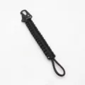 Black paracord keychain detail showing the sturdy woven texture and metal hook clip close-up. - Black