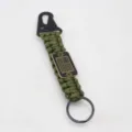 Close-up detail of the military green paracord survival keychain with US flag metal tag. - Army Green