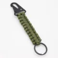 Paracord keychain detail view, military green woven rope with black tactical snap hook and ring. - Army Green