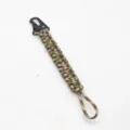 Detail view of durable 7-strand paracord keychain with black metal snap hook for outdoor use. - Army Green Camo