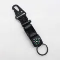 Detail view of tactical paracord survival keychain with compass, fire starter and carabiner. - Black