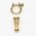 Detailed view of brass alloy U-shackle and buckle connector with vintage engraved totem design. - Gold (Patterned Round Head)