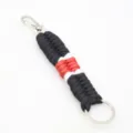 Close up detail of handmade black white red paracord keychain with sturdy metal hook. - Black and Red White