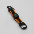 Close-up of the black and orange paracord keychain detail, featuring a built-in compass. - Orange And Black