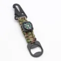 Close-up detail of the tactical paracord keychain with compass and metal bottle opener hook. - Army Green Camo