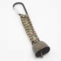 Close-up of outdoor hiking camping paracord bear bell with carabiner and vintage bronze metal bell. - Army Green Camo