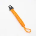 Orange paracord keychain with black carabiner hook, detailed view of braided tactical cord. - Orange