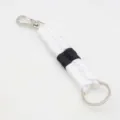 Handmade paracord keychain detailed view, black and white woven rope with metal hardware. - White & Black