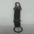 Black paracord keychain with carabiner and magnesium fire starter, multi-functional outdoor tool. - Black