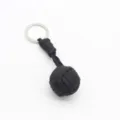 Black paracord keychain with woven monkey fist ball and metal ring, durable outdoor accessory. - Black (Steel Ball)