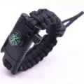 Close-up detail of black paracord survival bracelet with integrated compass and buckle. - Adjustable (Black)