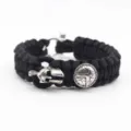Detailed close-up view of the black paracord survival bracelet with silver Spartan helmet. - Black
