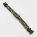 Paracord survival bracelet detail shot showing green woven cord and metal emblem clasp. - No. 206