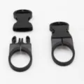 Detailed view of black plastic quick-release buckle and strap mount, showing sturdy structure. - Black