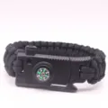Black paracord survival bracelet with built-in compass and whistle for outdoor camping. - Black