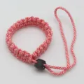 Red and white braided paracord camera wrist strap survival bracelet with black plastic buckle. - No. 272