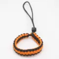 Black and orange paracord wrist strap, durable camera lanyard and outdoor survival braided bracelet. - Orange And Black
