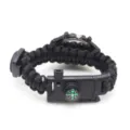 Black paracord survival watch detail view featuring a built-in compass and durable buckle. - Black