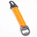 Orange paracord keychain with black tactical carabiner and integrated bottle opener hook. - Orange