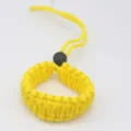 Detailed close-up of yellow woven paracord camera wrist strap showing fine texture and strong loop. - Yellow