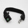 Black paracord survival bracelet with digital watch, compass, and multi-tool buckle. - Black